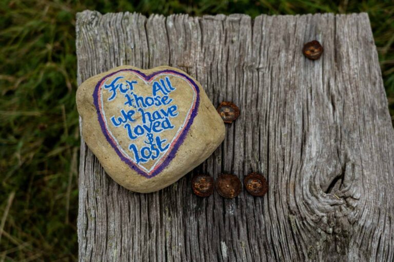 Grief: A heart-shaped rock with the words "For all those we have loved & Lost" painted on it.