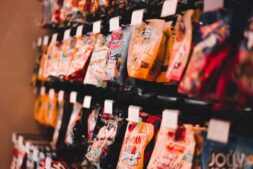 A vibrant display of assorted candy packets on a store shelf, perfect for marketing or retail content. New SNAP regulations