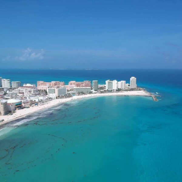 Discover the vibrant turquoise waters and pristine beaches of Cancun's iconic shoreline. Caribbean tourism