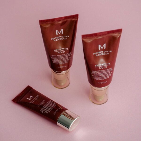 BB cream tubes on a vibrant pink background showcasing skincare and cosmetics. K-Beauty