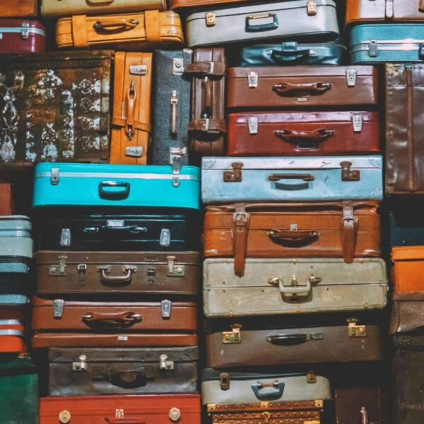 Labor Day, luggage sales, A colorful assortment of vintage suitcases stacked together, creating an artistic display.