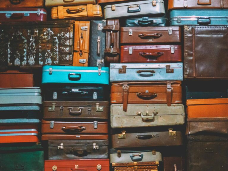 Labor Day, luggage sales, A colorful assortment of vintage suitcases stacked together, creating an artistic display.