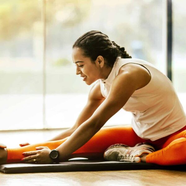 A woman enjoying a yoga stretch indoors, promoting a healthy lifestyle. stretching