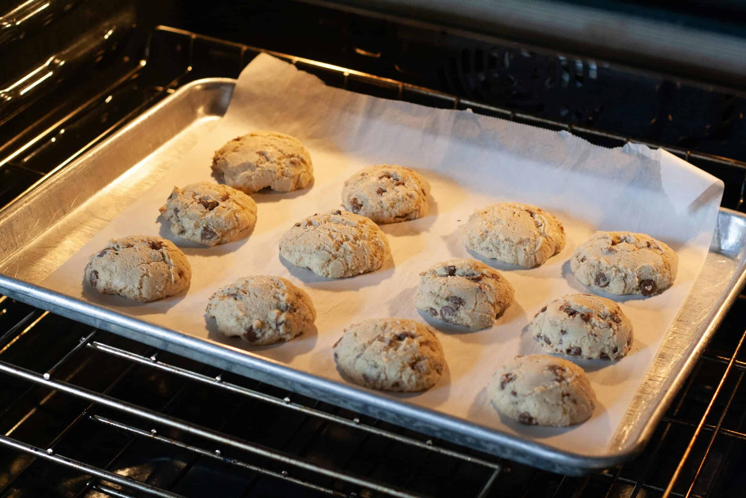 Delicious homemade chocolate chip cookies baking in an oven, fresh and ready to serve.