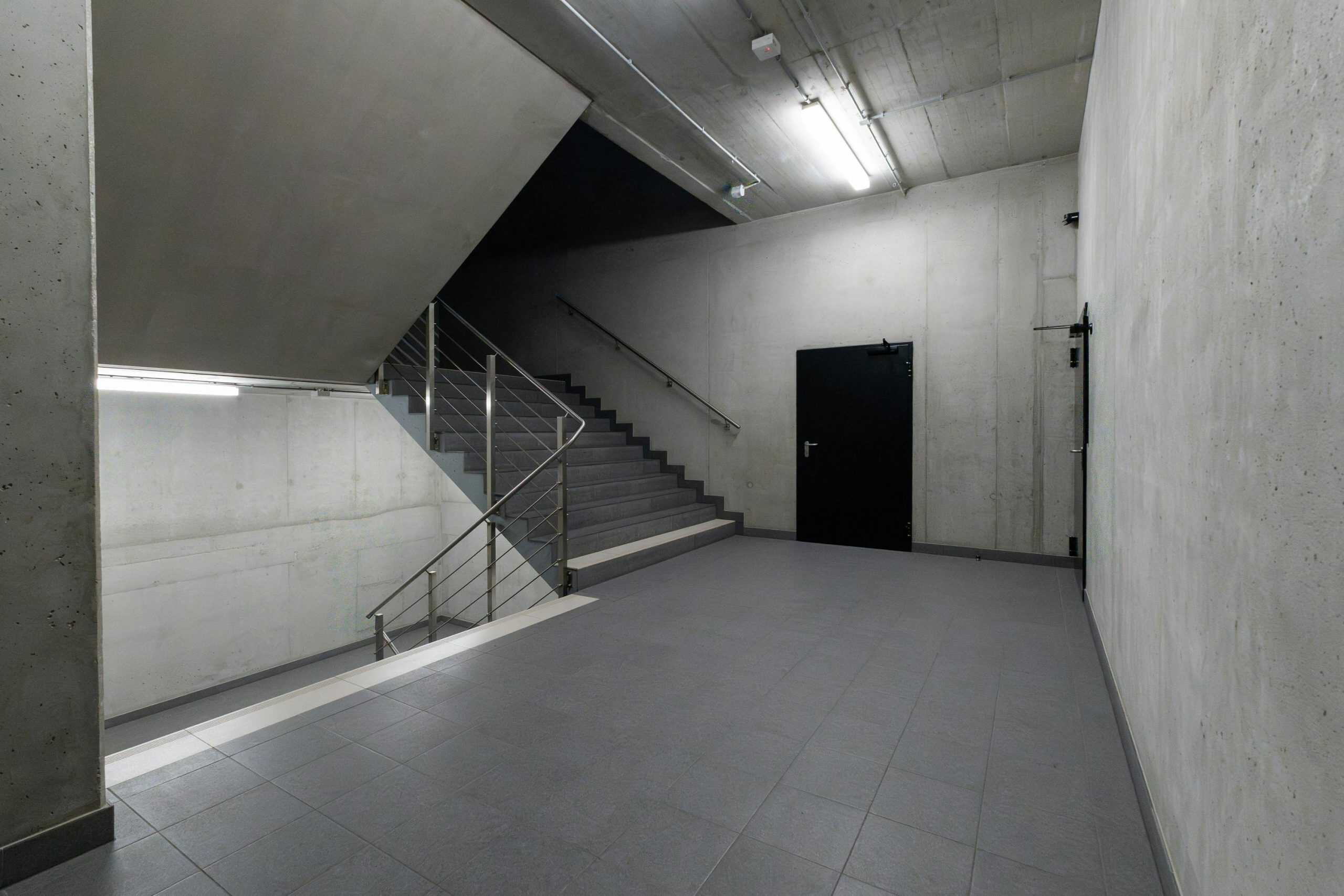 A modern and minimalist concrete stairwell showcasing industrial architecture.