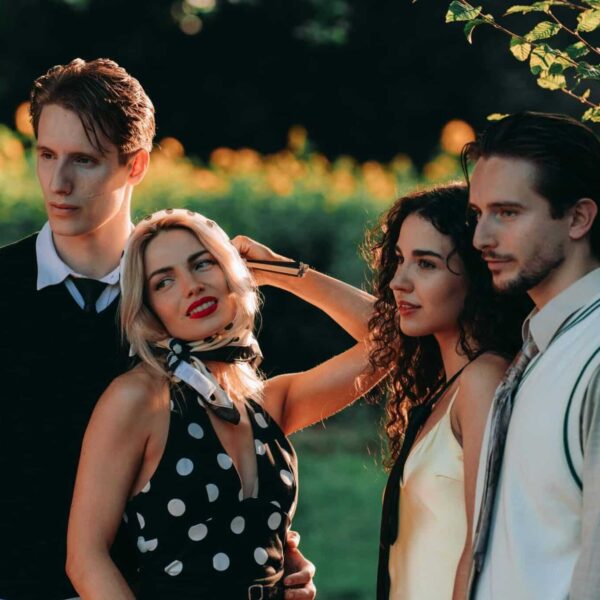 Four fashionable friends enjoying a sunny day in a garden setting. narcissism epidemic