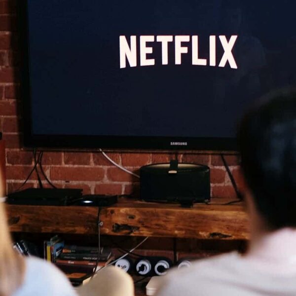 A couple relaxing and watching Netflix in a cozy living room setting.