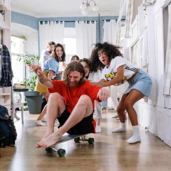 college roommates, A group of friends enjoying playful moments indoors, showcasing youthful spirit and camaraderie.