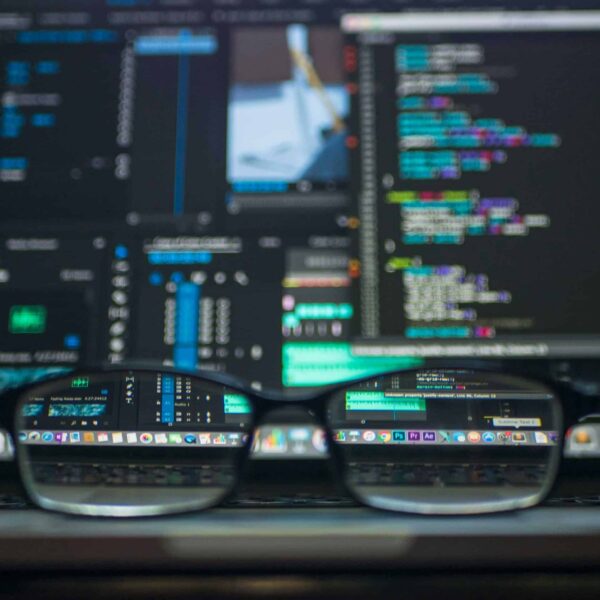 Eyeglasses reflecting computer code on a monitor, ideal for technology and programming themes. AI/ google