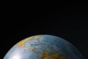 Focused image of a globe highlighting Cuba and Central America with a dark background. Daily devotion