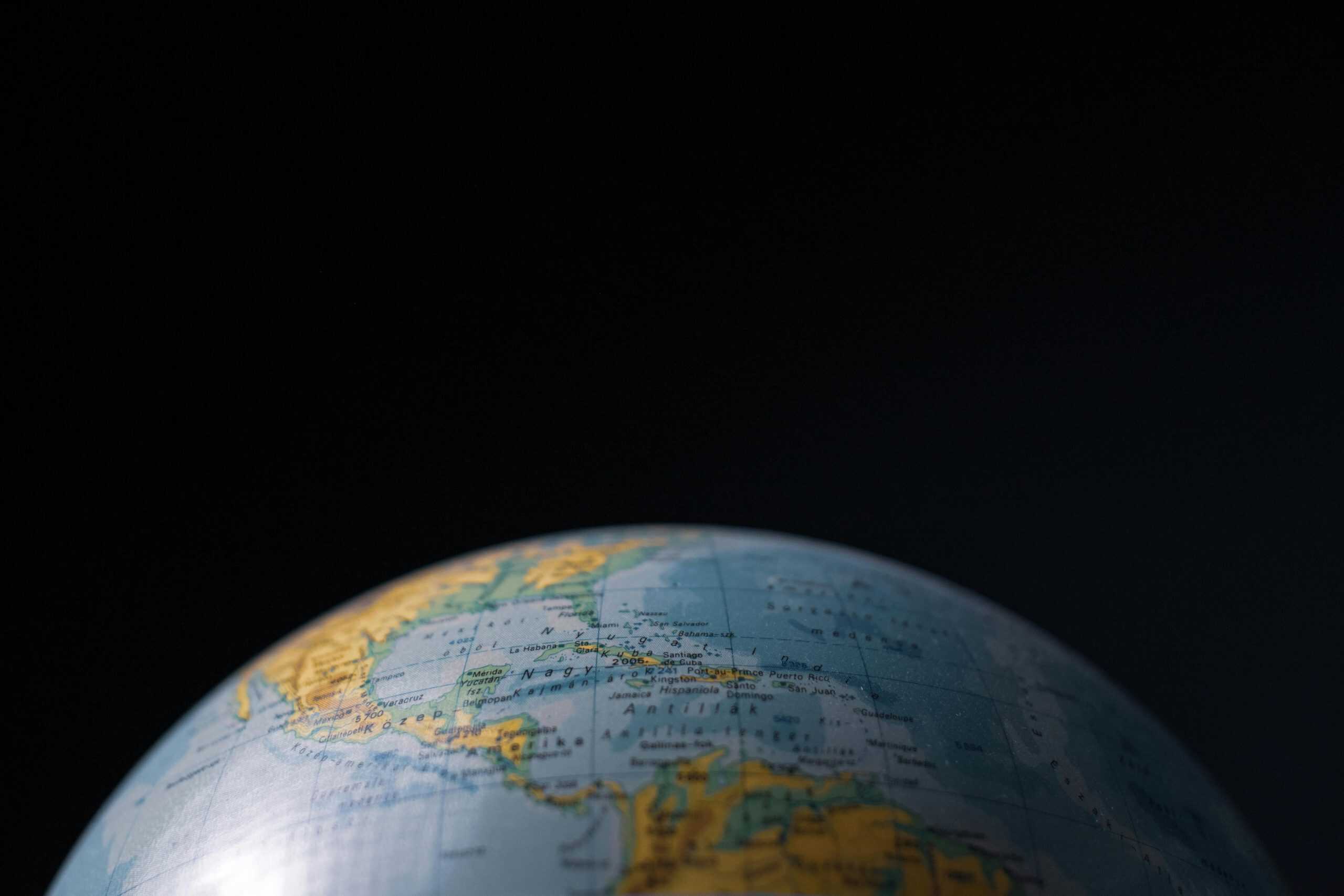 Focused image of a globe highlighting Cuba and Central America with a dark background. Daily devotion