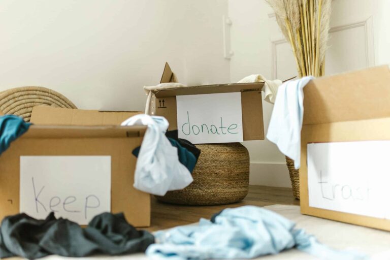 Cardboard boxes labeled keep, donate, and trash for effective home organization. declutter