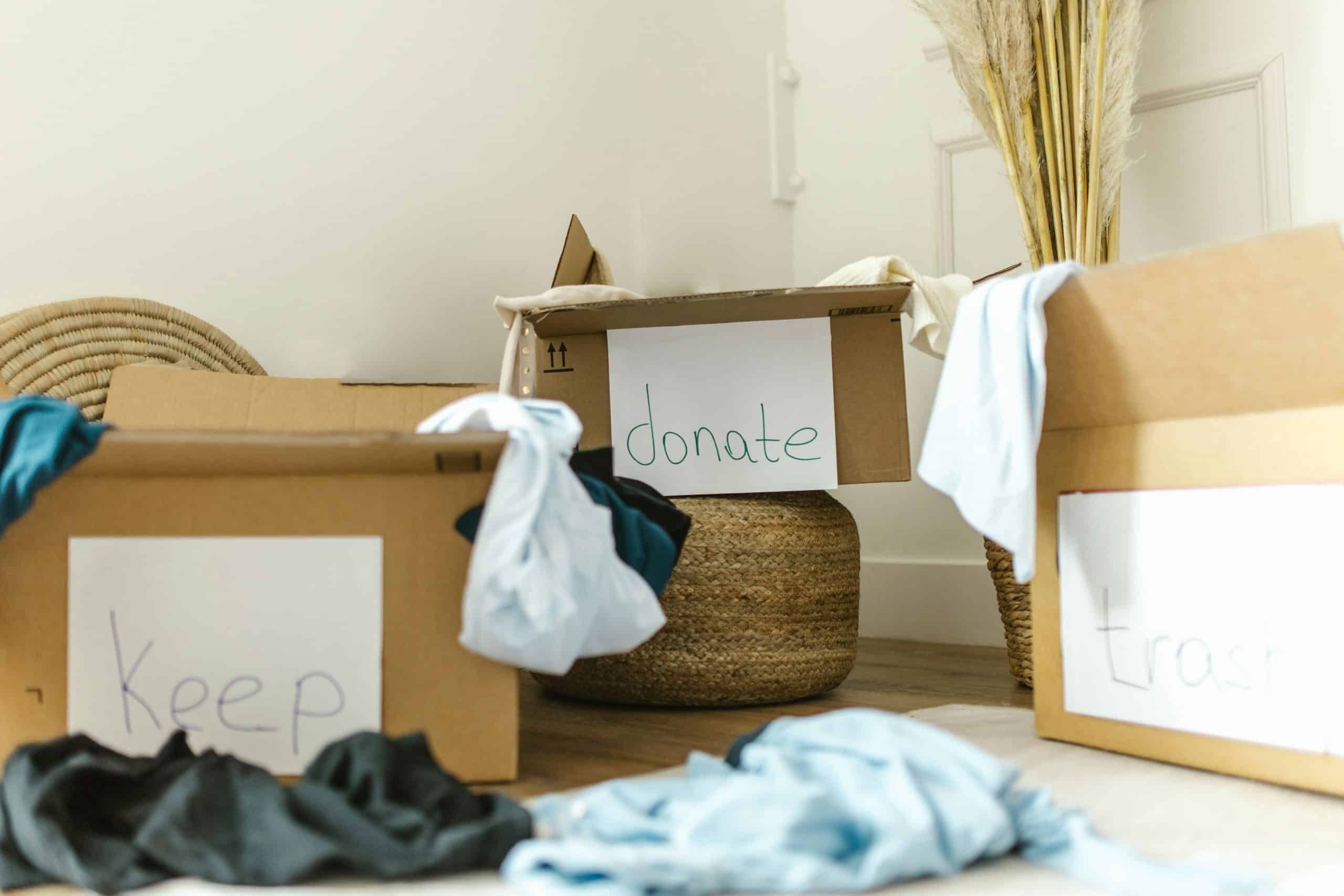 Cardboard boxes labeled keep, donate, and trash for effective home organization. declutter