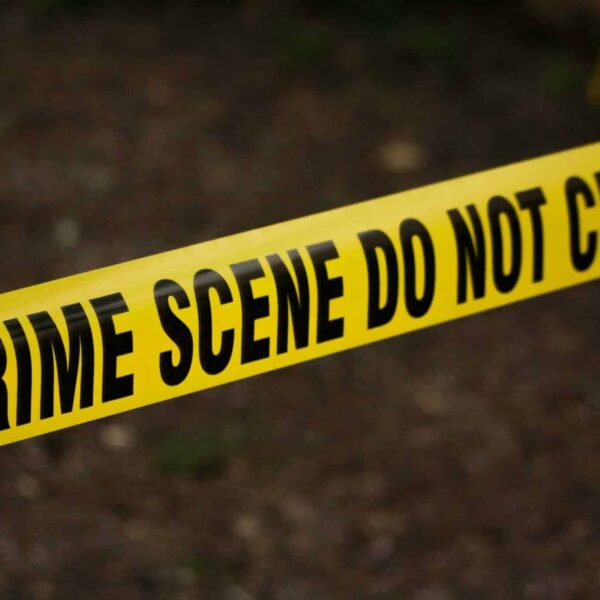 True-crime series concept image showing a close-up of yellow crime scene tape with “Do Not Cross” text in an outdoor setting. Photo by Kat Wilcox via Pexels.