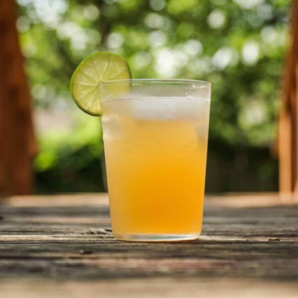 clear drinking glass with drink and lime slice / National Rum Day
