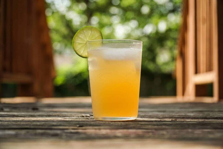 clear drinking glass with drink and lime slice / National Rum Day