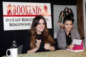 Khloe and Kourtney Kardashian (L-R) pose for photos as they arrive for their book signing Wednesday evening at Bookends in Ridgewood, November 16, 2011.