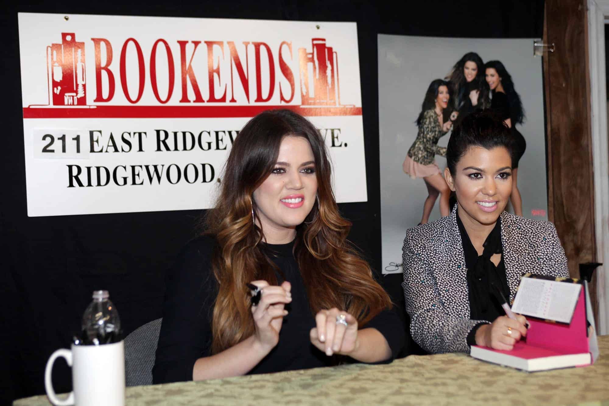 Khloe and Kourtney Kardashian (L-R) pose for photos as they arrive for their book signing Wednesday evening at Bookends in Ridgewood, November 16, 2011.