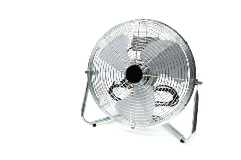 Sleek stainless steel industrial fan with metal blades, similar in design to attic fan motors, isolated on a white background.