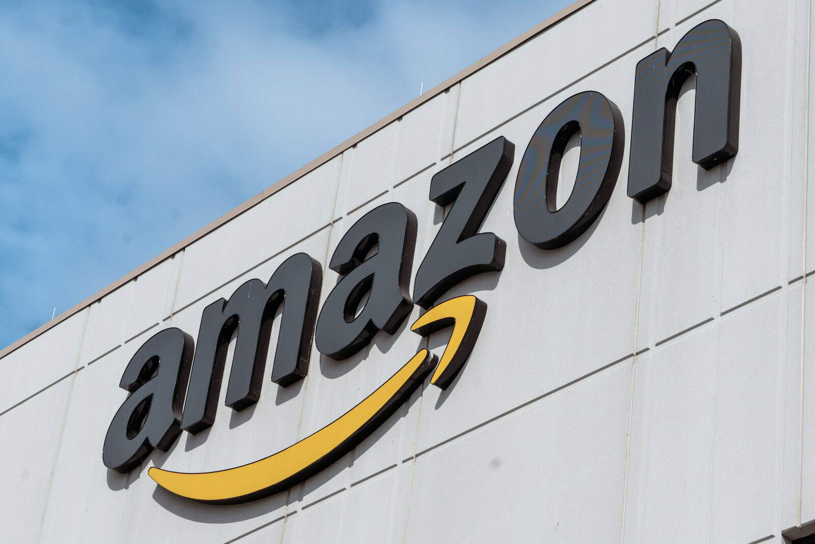 The Amazon logo is displayed on a building. Amazon Prime, Prime Days, Fall Fashion Deals
