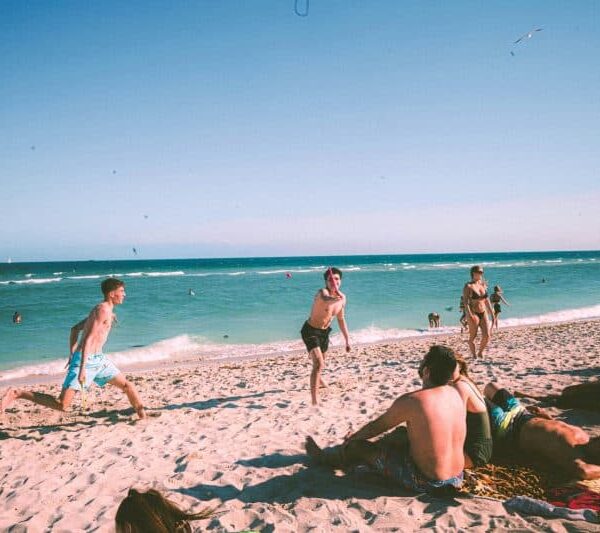 Teenagers on the beach, viral teen tattoo trend, sunburn tattoo
