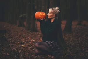 woman in black sweater holding pumpkin, Sexy Halloween Costume