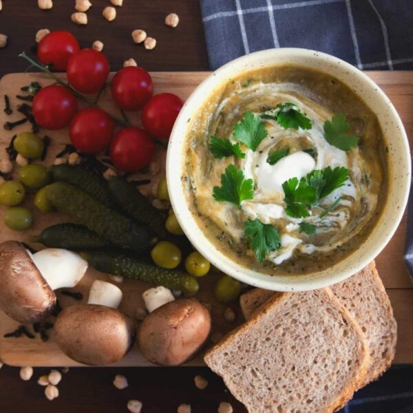 Delicious creamy soups with fresh vegetables and bread, perfect for food lovers seeking cozy comfort.