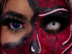 Dramatic close-up of Halloween SFX makeup with detailed face painting and colored contacts. Halloween contact lenses