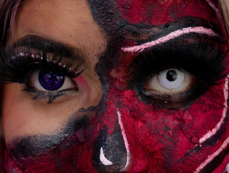 Dramatic close-up of Halloween SFX makeup with detailed face painting and colored contacts. Halloween contact lenses