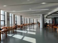 campus food trends, A modern university canteen in China with wooden tables and natural daylight streaming in.