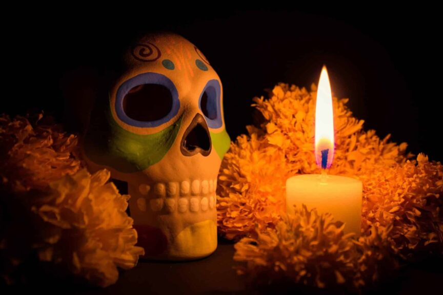 Stewardship, harvest season, Colorful skull and candlelight with marigold flowers for Dia de los Muertos.