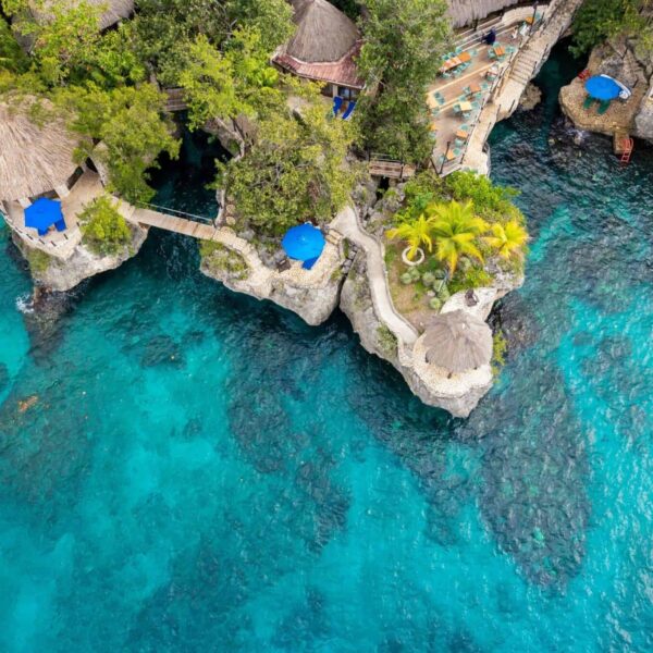Bluefields Bay Villas, Stunning aerial view of a cliffside resort in Negril, Jamaica, featuring turquoise waters and natural architecture.