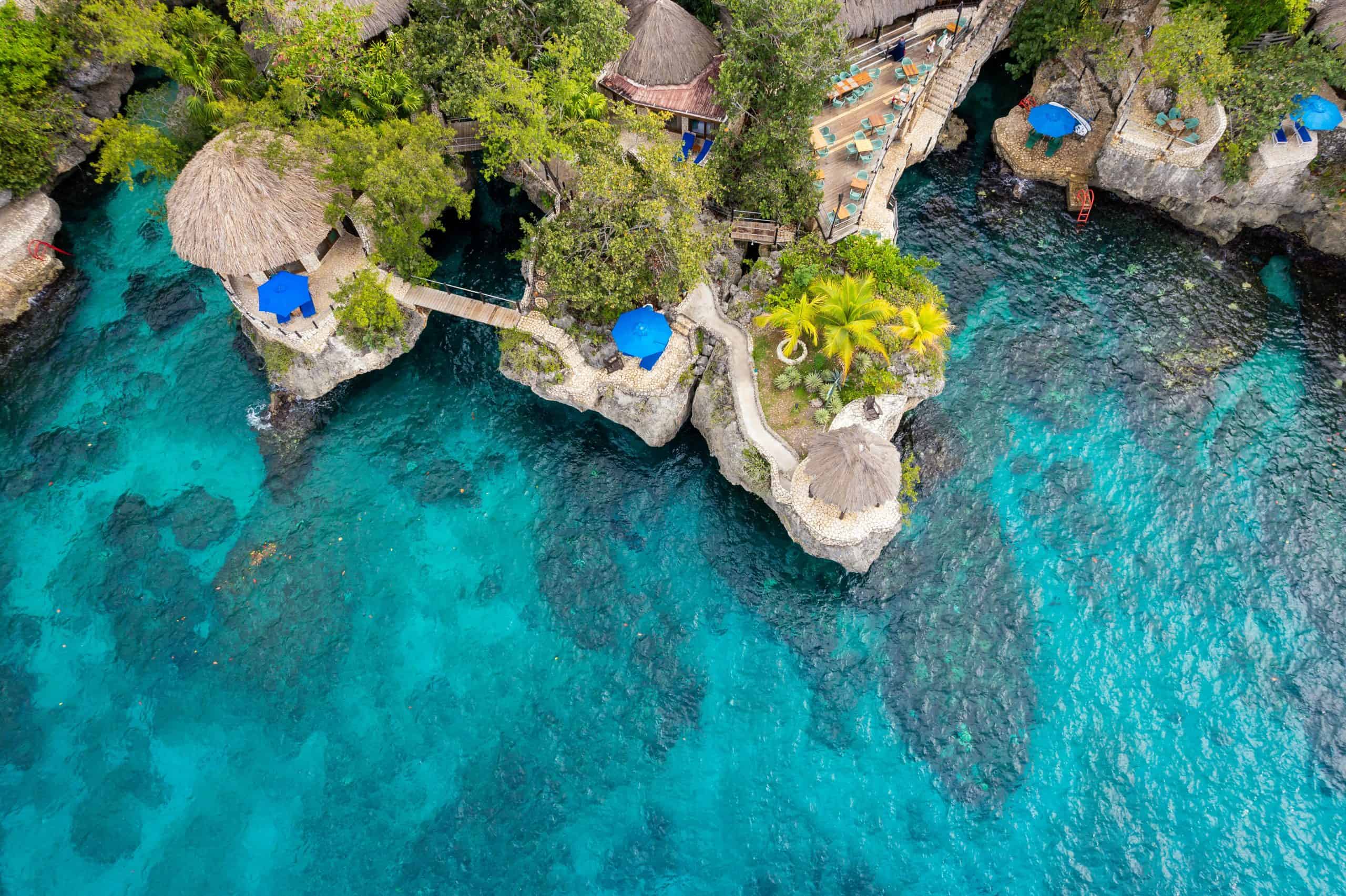 Bluefields Bay Villas, Stunning aerial view of a cliffside resort in Negril, Jamaica, featuring turquoise waters and natural architecture.