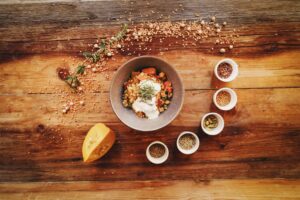 Healthy, pumpkin spice, Top view of a rustic vegetarian bowl and spices placed on a wooden table, ideal for recipe inspiration.