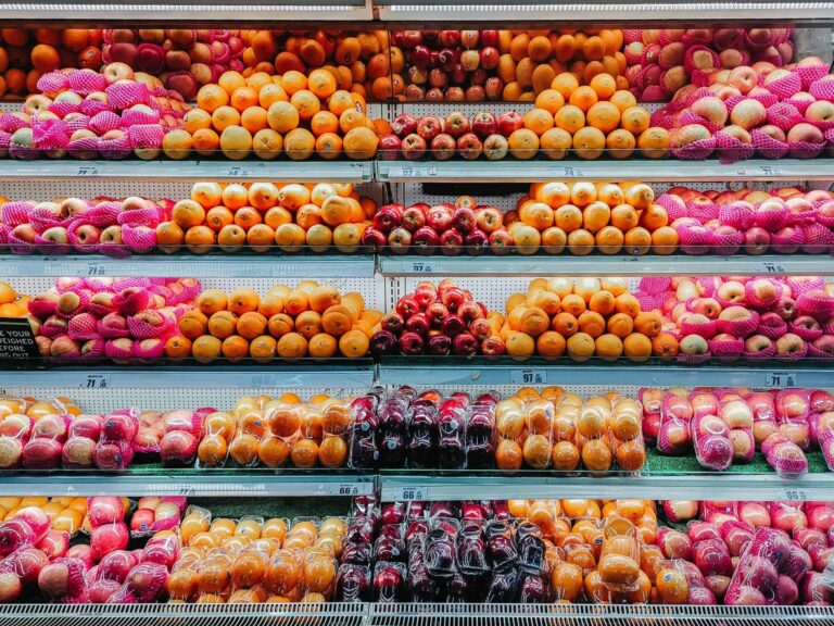 Colorful variety of fresh fruits neatly arranged on supermarket shelves, showcasing abundance and freshness. Pesticides, fruits and vegetables,
