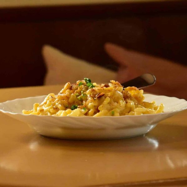 Close-up shot of gourmet mac and cheese on a table, perfect for food blogs.