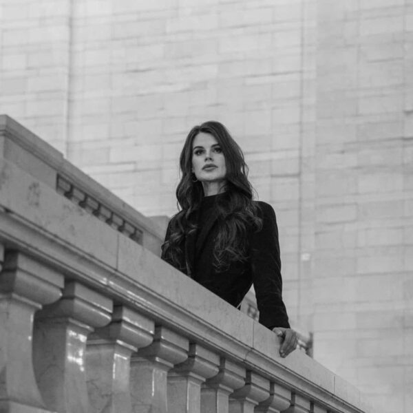 This photograph features a woman standing in a New York setting. NYFW (New York Fashion Week) for September 2025 has engaging design presentations.