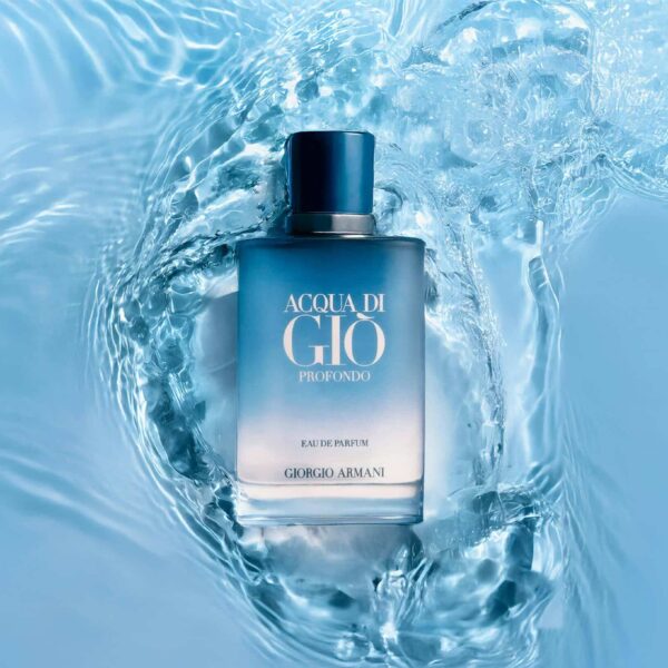 A stylish perfume bottle submerged in calming blue water, evoking freshness and elegance. Armani