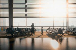 Families on the Fly, Silhouettes of travelers in a sunlit airport terminal in Shanghai, China.