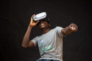 A young black man enjoying virtual reality with a headset, indoors.AR and VR Sports Games