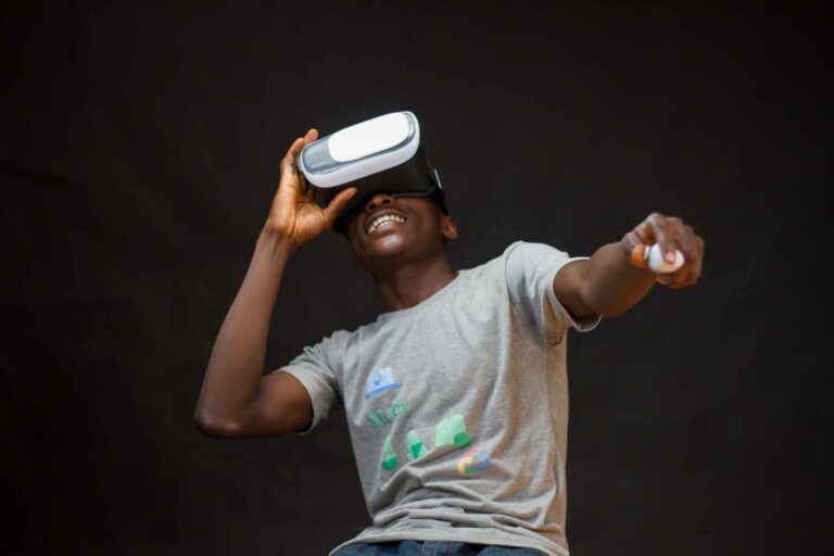 A young black man enjoying virtual reality with a headset, indoors.AR and VR Sports Games
