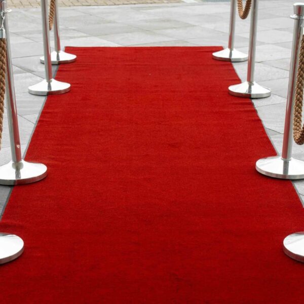 Emmy Awards, Red carpet entrance with stanchions on a tiled outdoor surface, perfect for events.
