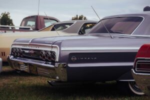 Classic Chevrolet Impala on display at an outdoor car show, showcasing vintage automotive design. Chevy Impala
