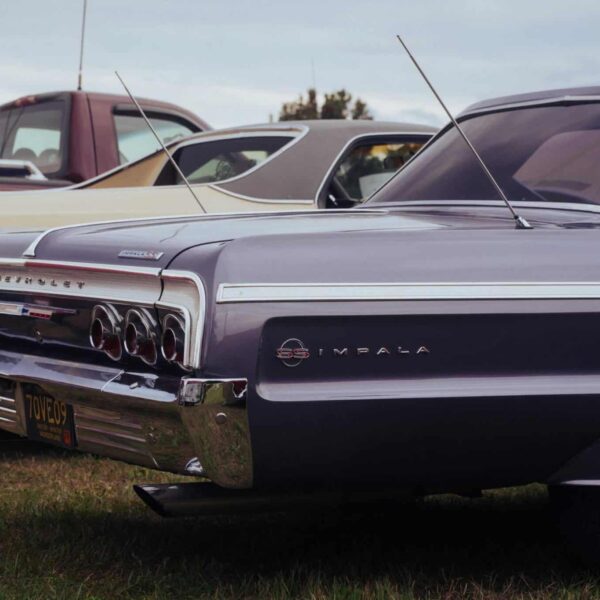 Classic Chevrolet Impala on display at an outdoor car show, showcasing vintage automotive design. Chevy Impala