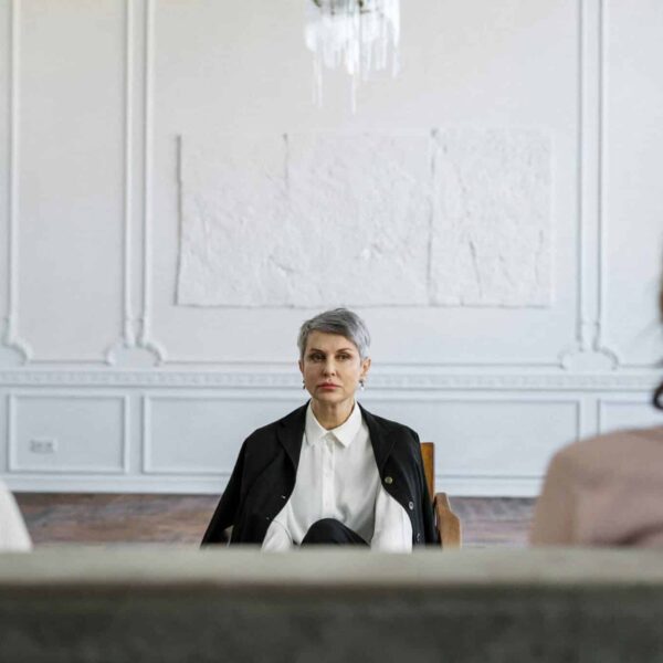 A married couple in a consulting session with a therapist in a modern, minimalistic office. conscious uncoupling