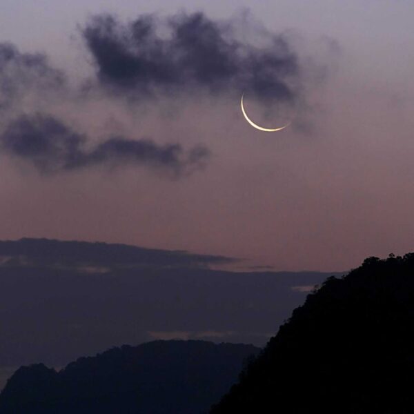New Moon, Virgo, Crescent moon with dark clouds in twilight sky over Phang-nga, Thailand.