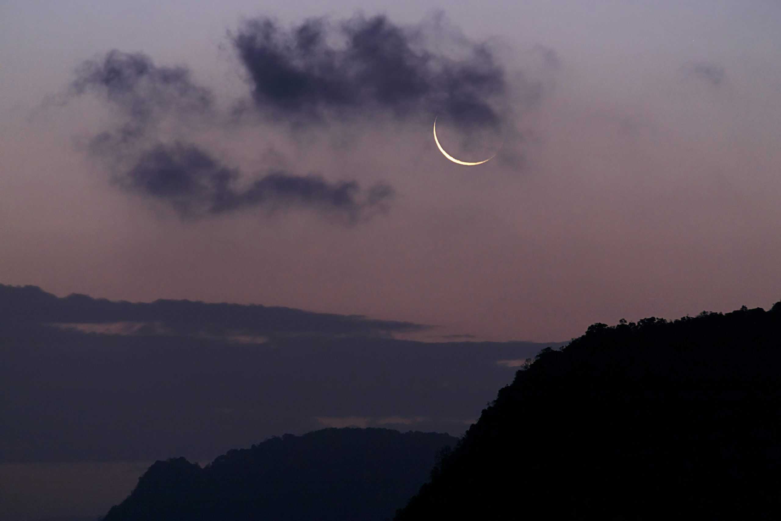 New Moon, Virgo, Crescent moon with dark clouds in twilight sky over Phang-nga, Thailand.