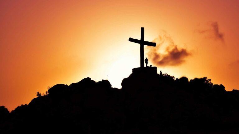 needs not being prioritized, Majestic silhouette of a cross on a hill during a vivid sunset, symbolizing spirituality.