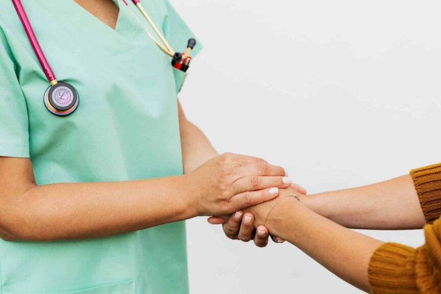 Close-up of a doctor holding a patient's hands, symbolizing trust and empathy in healthcare. advocating, chronic illness, advocate