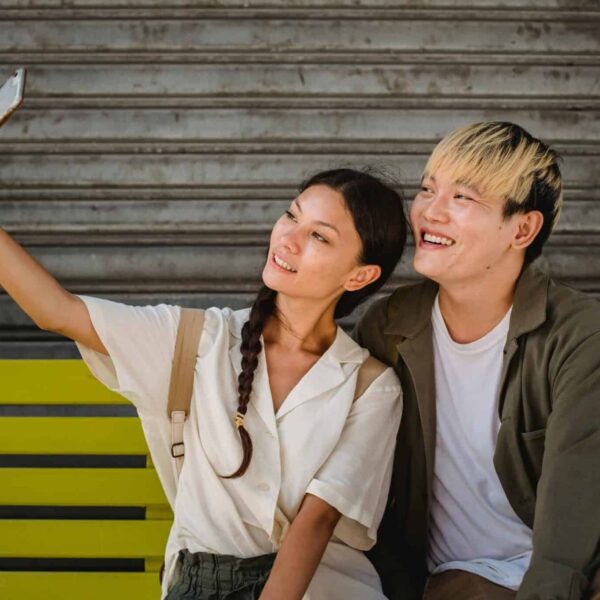 This photograph is of a couple taking a selfie together. Soft-launching a relationship through social media can let people how excited you are.